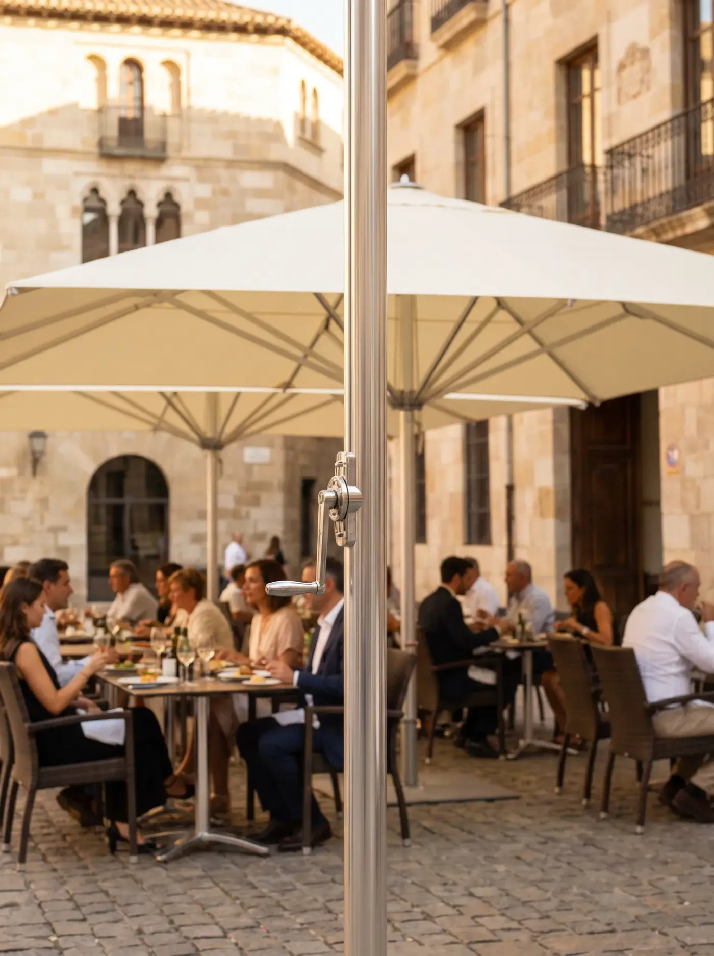 Glatz commercial parasol shading an outdoor dining terrace — Swiss-engineered shade systems